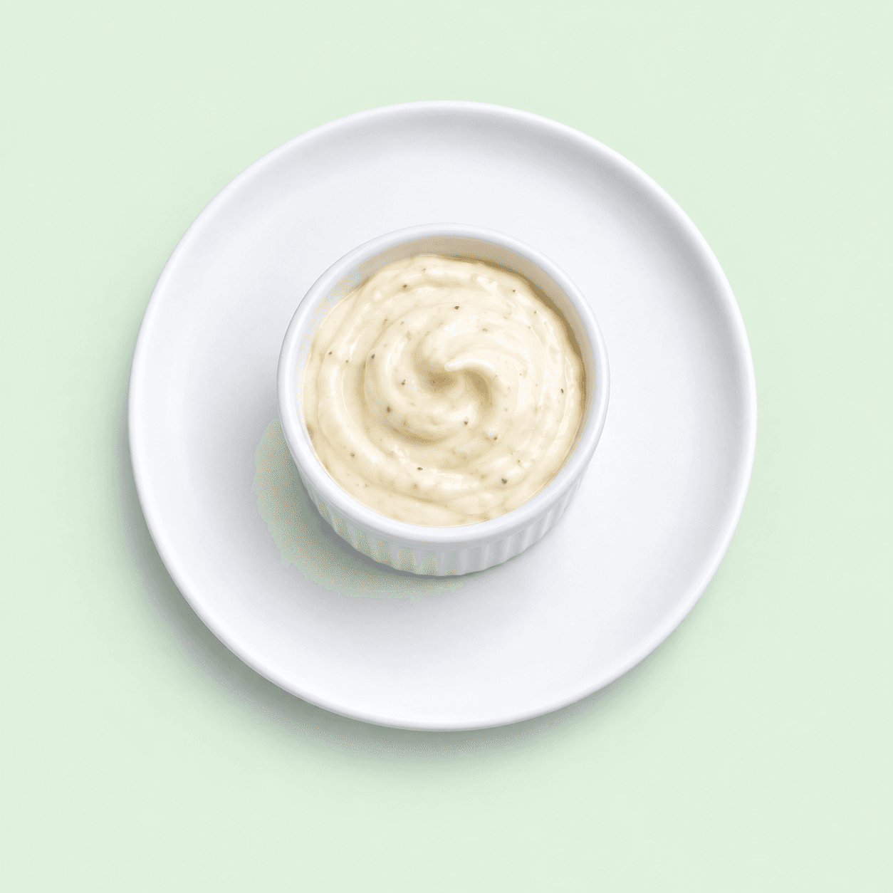 Creamy garlic aioli in a small white ramekin
