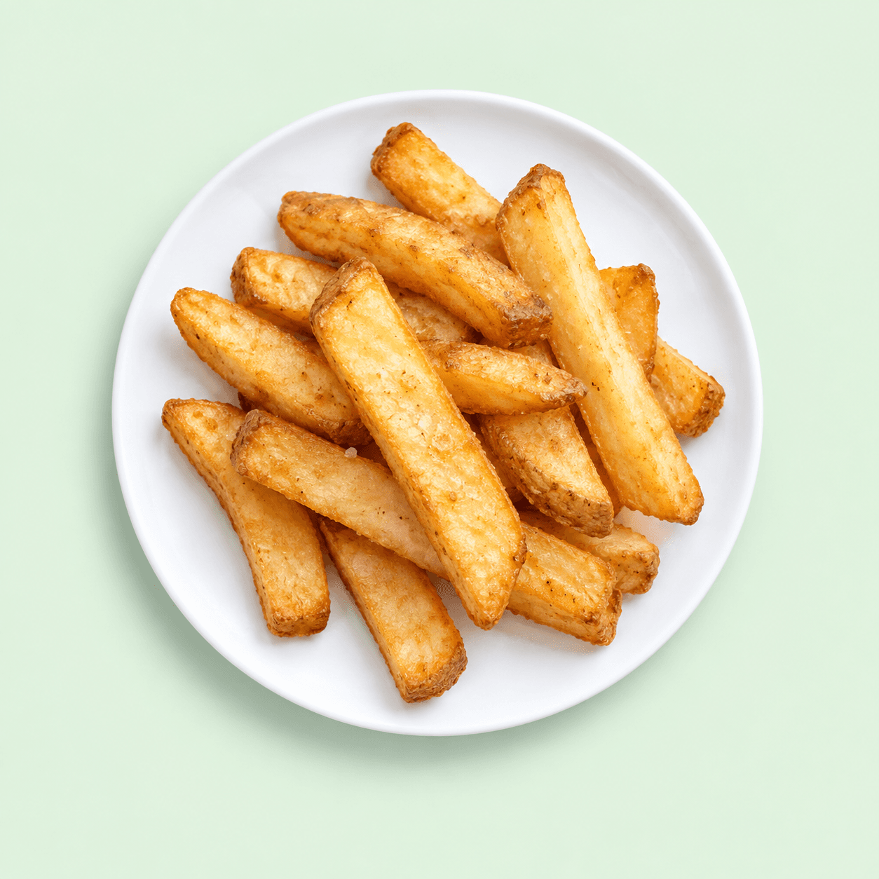 Thick golden steak fries on a white plate